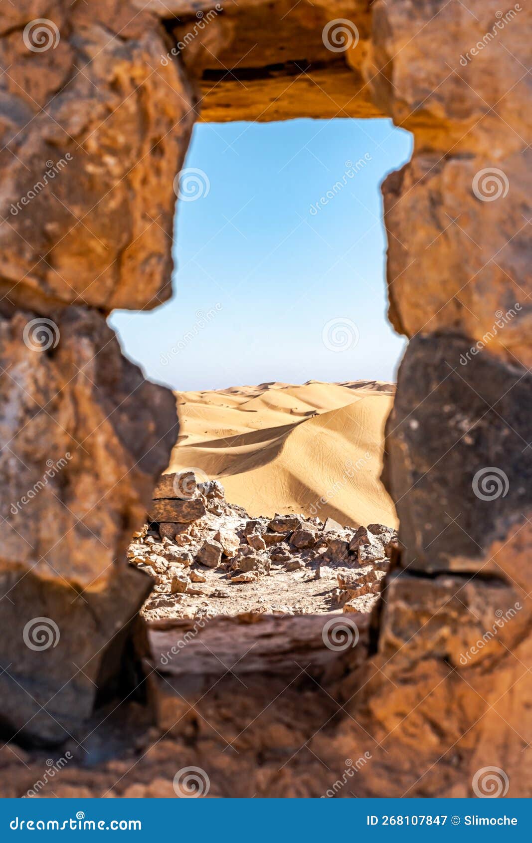 aerial view through a blurred stone window from the ruines of djebel baroun mountain.