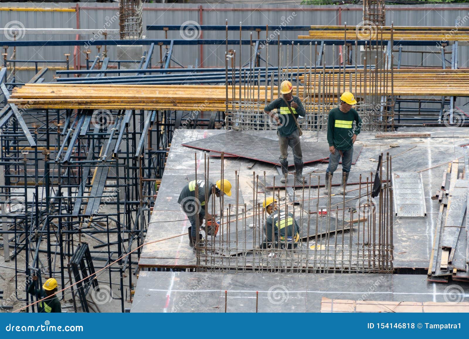 Aerial View of Busy Industrial Construction Site Workers with Cranes