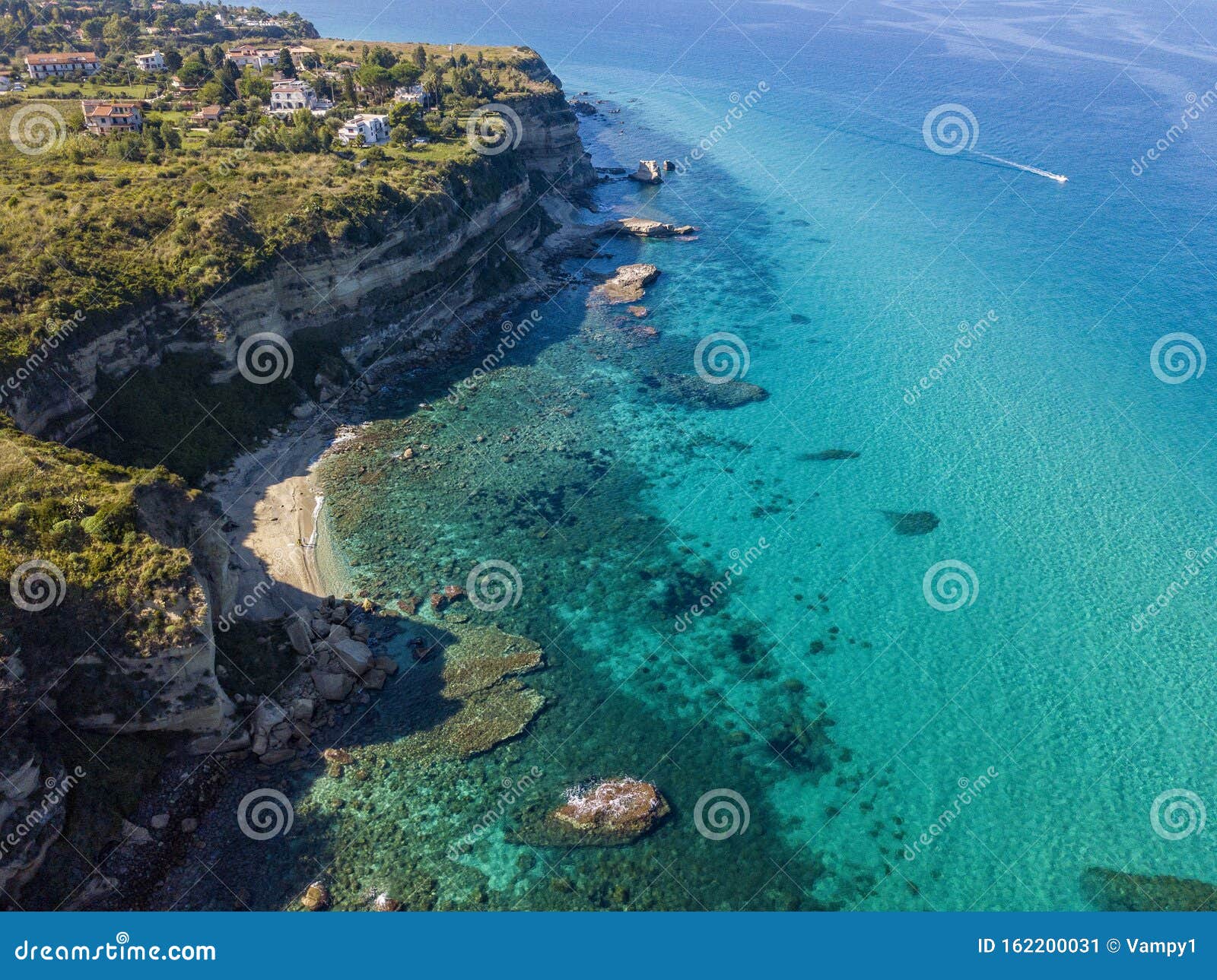 aerial view of the calabrian coast, cliffs overlooking the crystal clear sea and luxury villas. riaci, tropea, italy