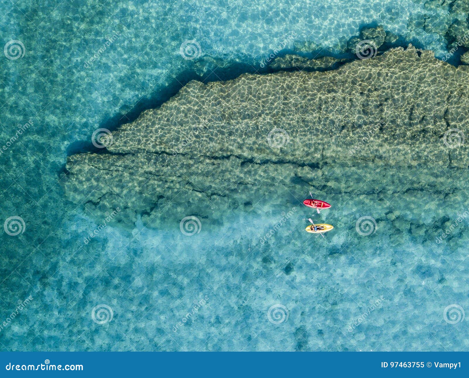 aerial view of a canoe in the water floating on a transparent sea. bathers at sea. zambrone, calabria, italy
