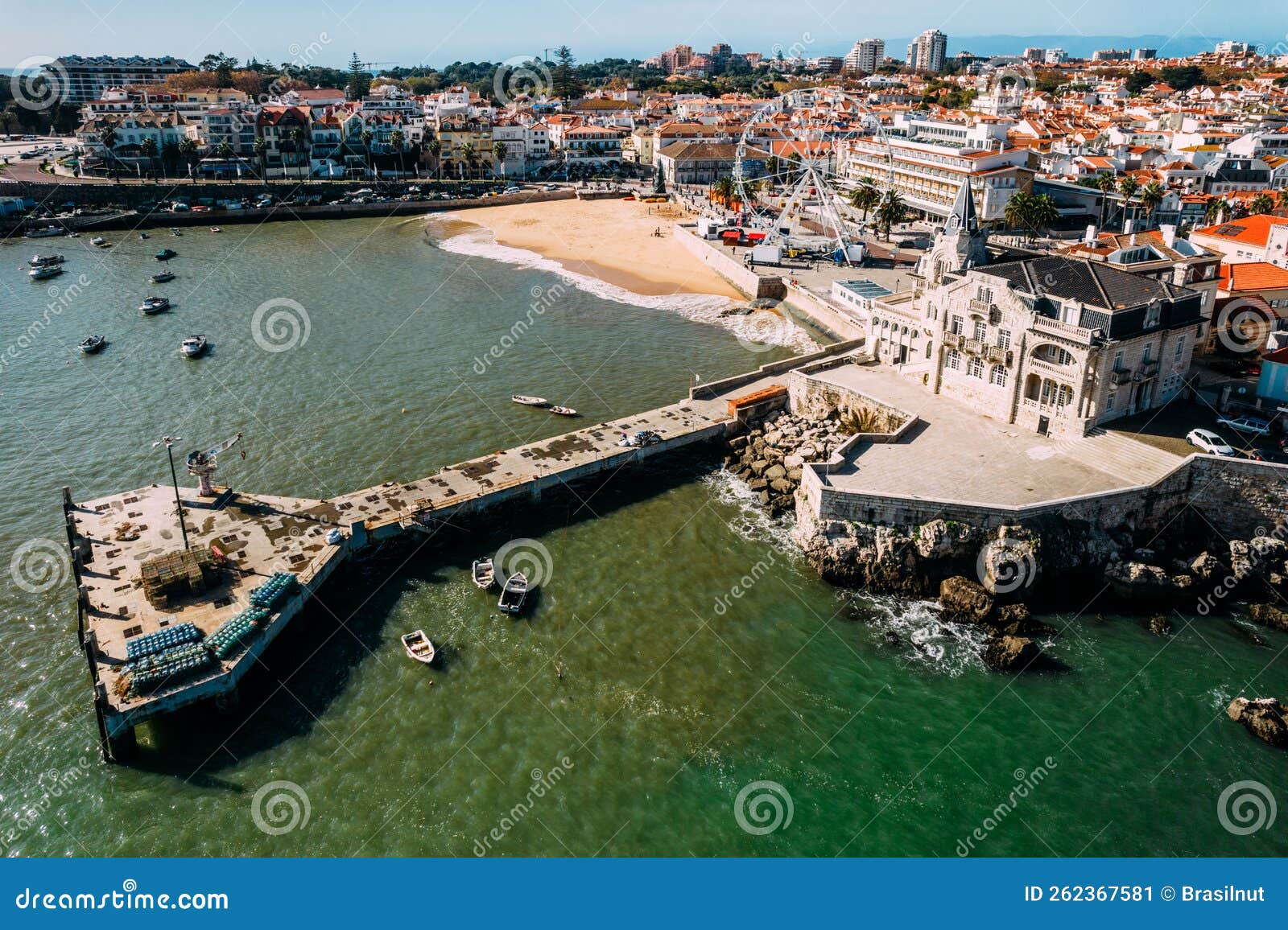 aerial view of cascais bay, portugal with giant ferris wheel visible which was set up for the christmas season