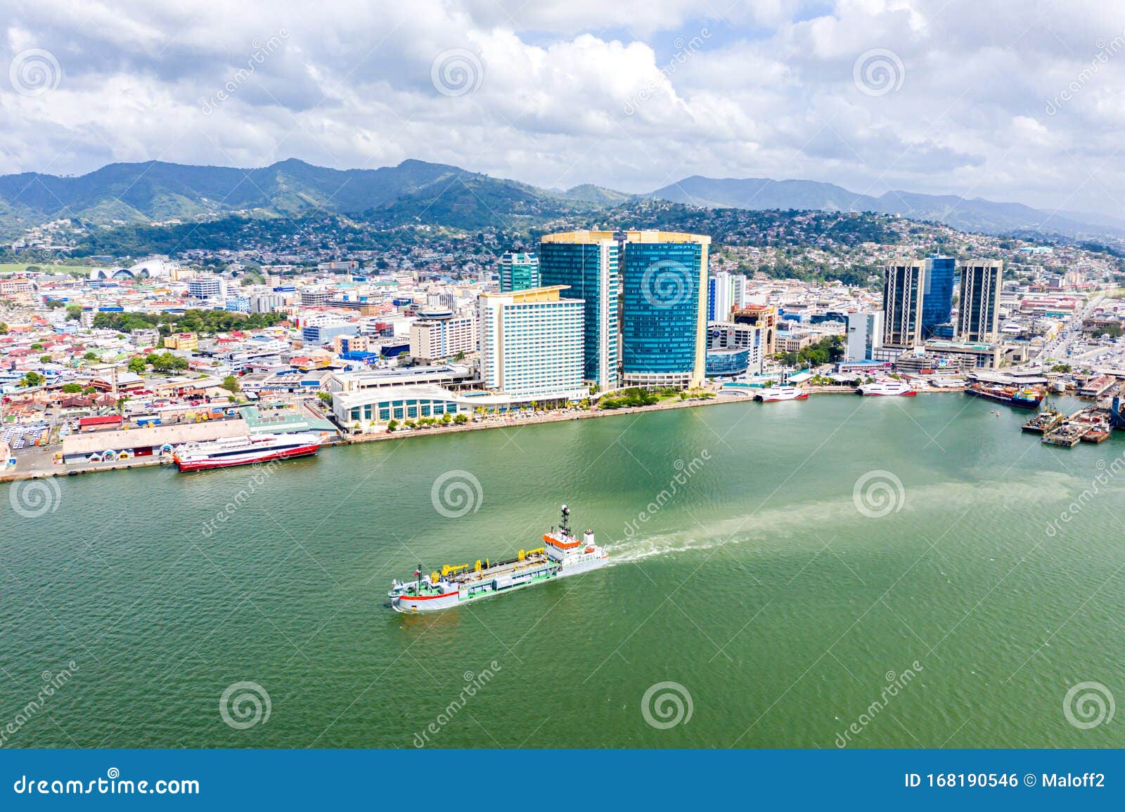 aerial view of city of port of spain, the capital city of trinidad and tobago. skyscrapers of the downtown and a busy sea port