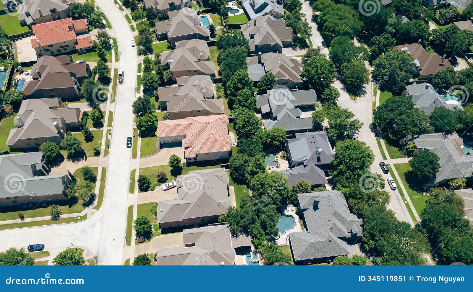 aerial view colorful concrete roof tiles on row of large two-story suburban mansion single-family houses swimming pools in upscale