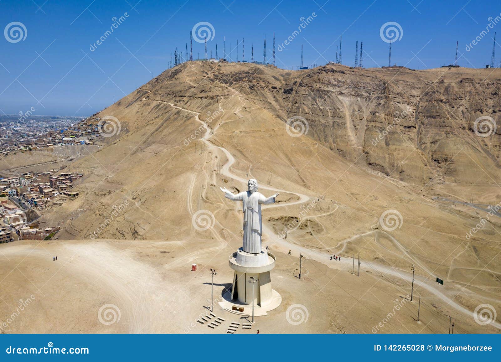 aerial view of cristo del pacifico and morro solar hill in the background