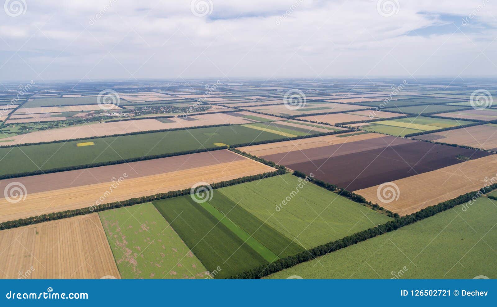 Aerial View of Fields with Various Types of Agriculture, Against Cloudy ...