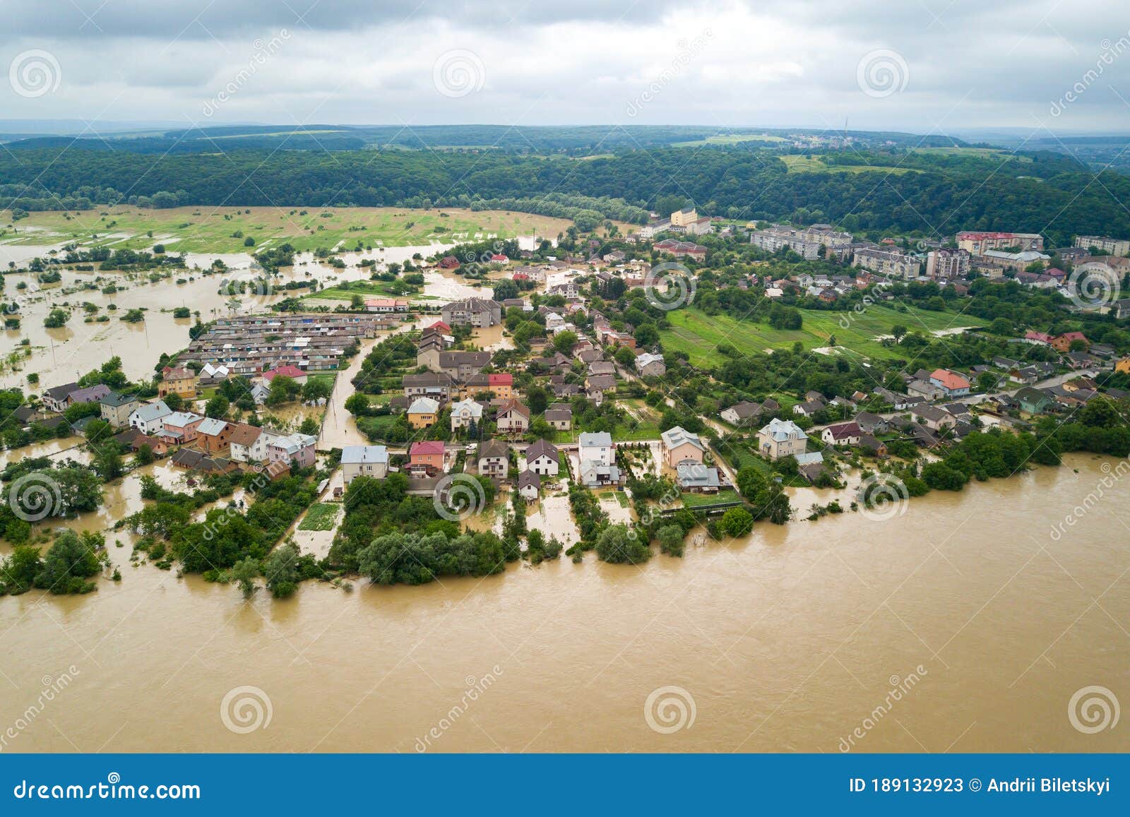 aerial view of flooded houses with dirty water of dnister river in halych town, western ukraine