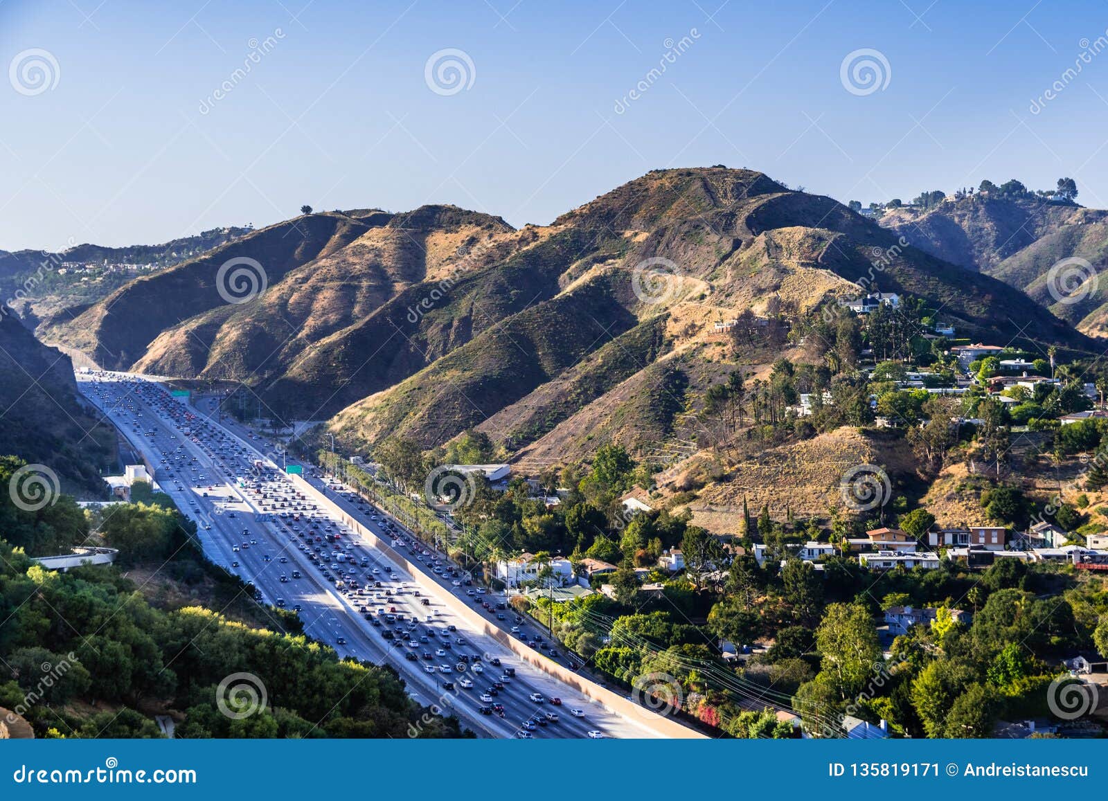 aerial view of highway 405 with heavy traffic; the hills of bel air neighborhood in the background; los angeles, california