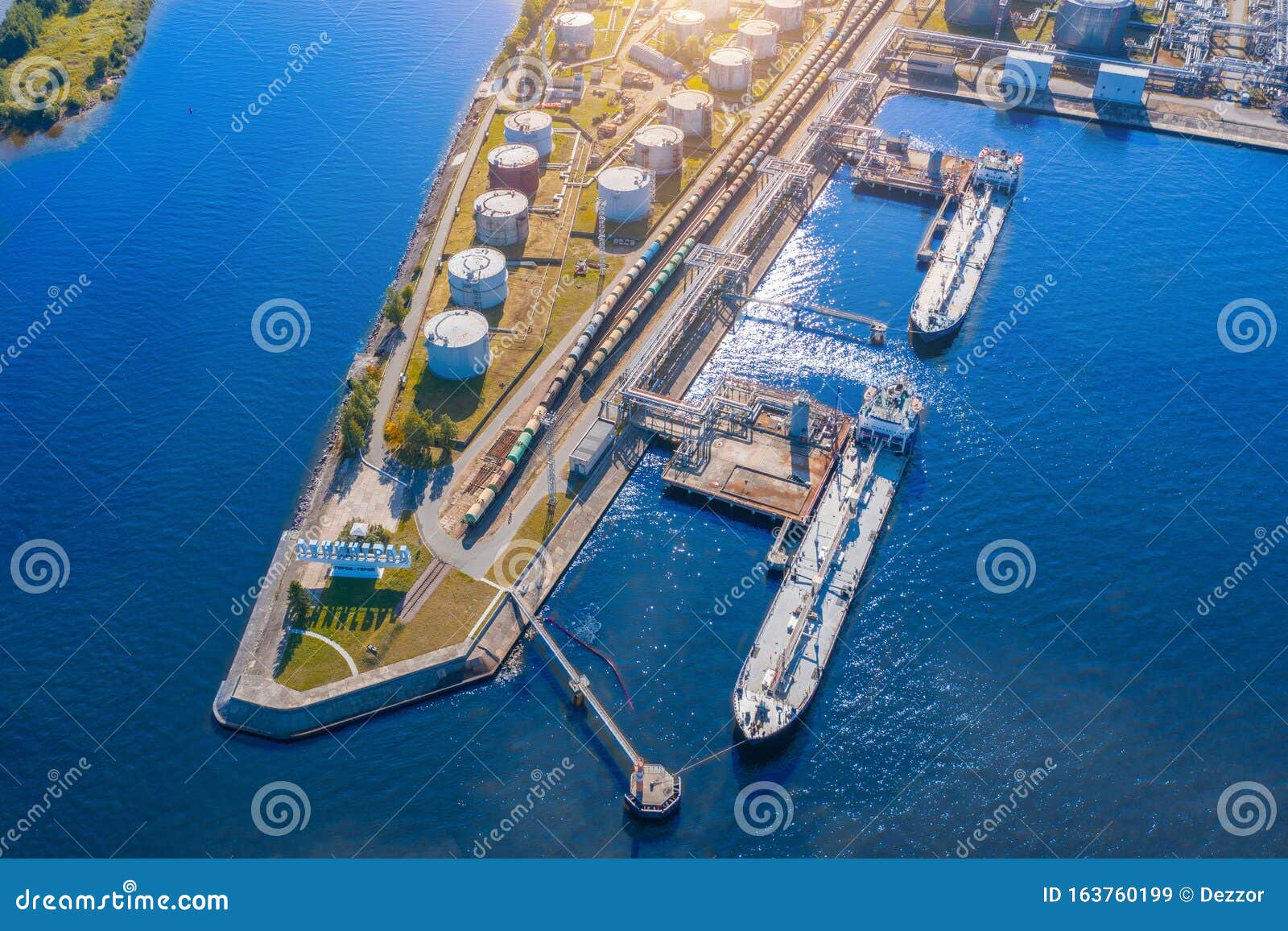 aerial view large port oil loading terminal with large storage tanks. railway infrastructure for the delivery of bulk cargo by sea