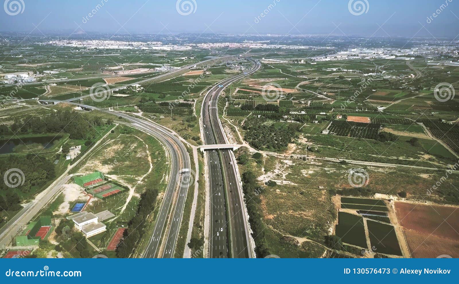 aerial view of major highway traffic on a sunny day, autopista del mediterraneo, spain