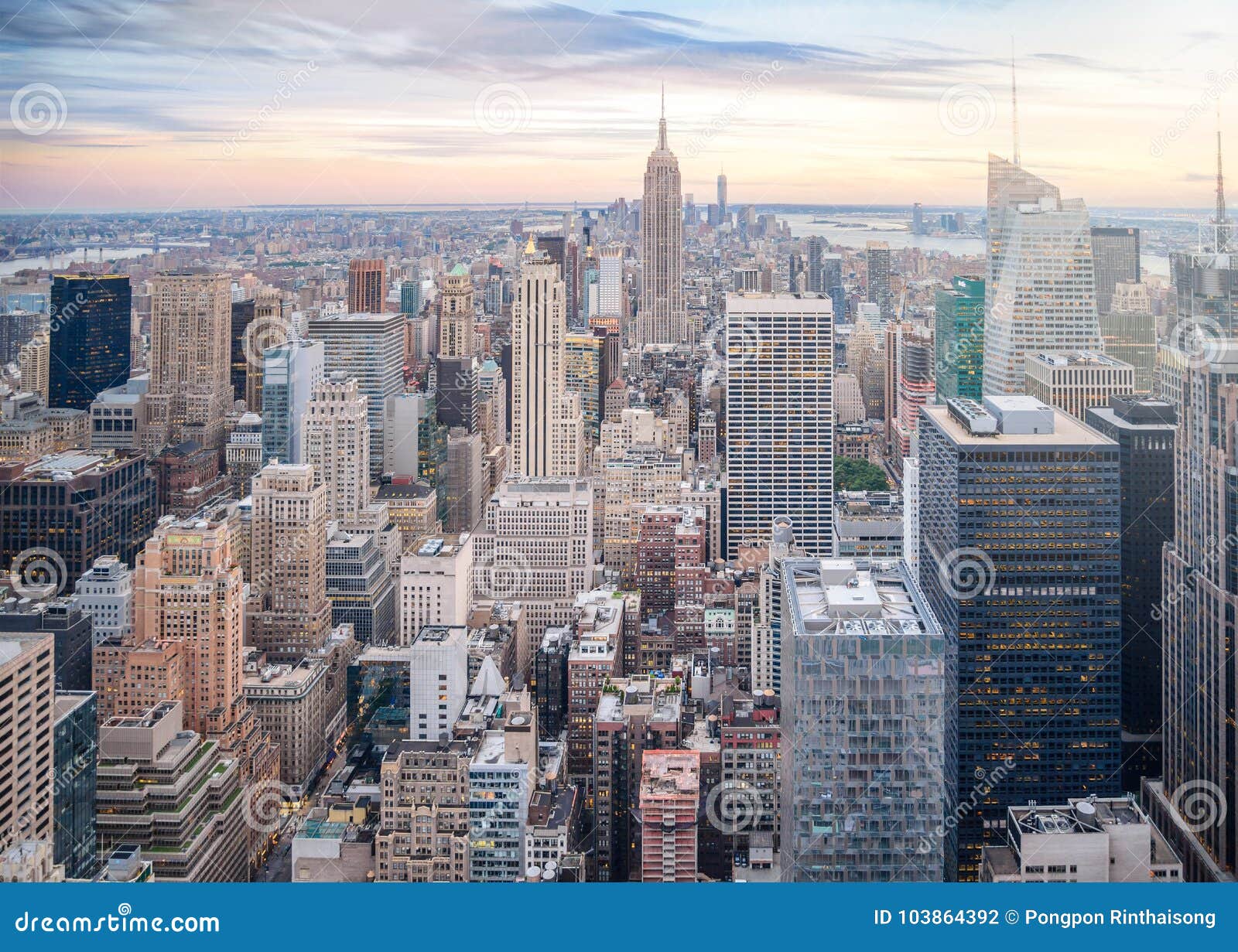 aerial view of manhattan skyline, skyscraper in new york city at sunset in evening