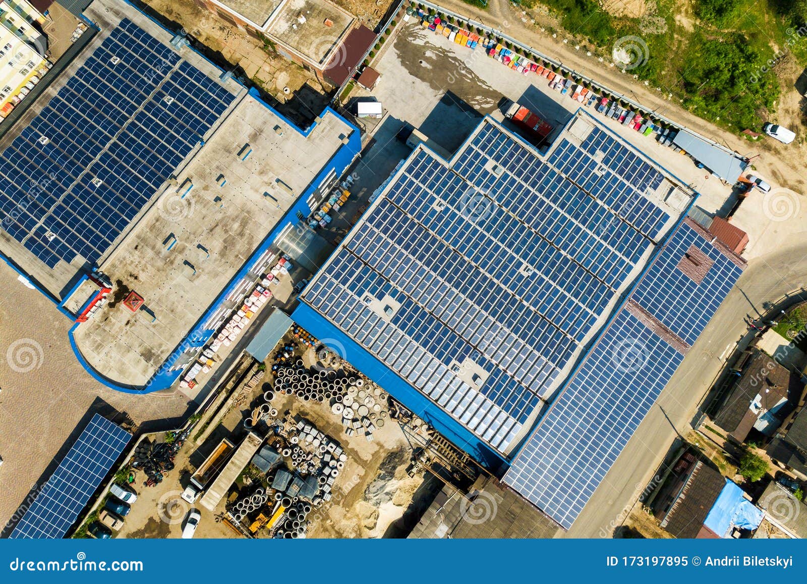 aerial view of many photo voltaic solar panels mounted of industrial building roof