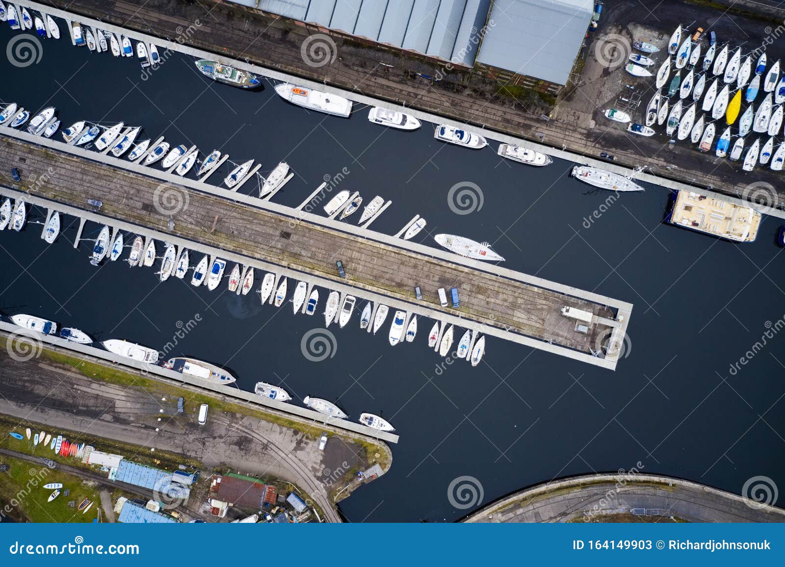 aerial view of marina with boats and yachts from above in row and pontoon