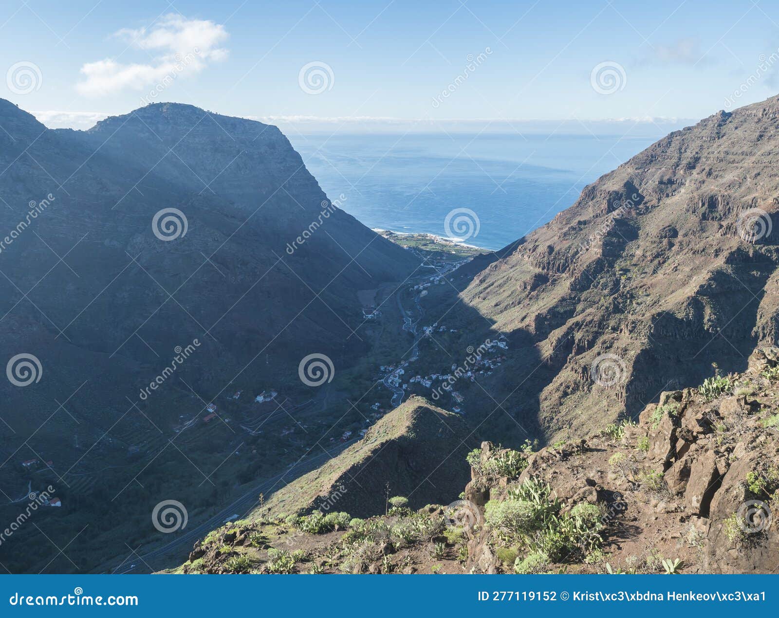 aerial view from mirador de la curva del queso. green valley of valle gran rey with mountain cliffs, ocean and colorful