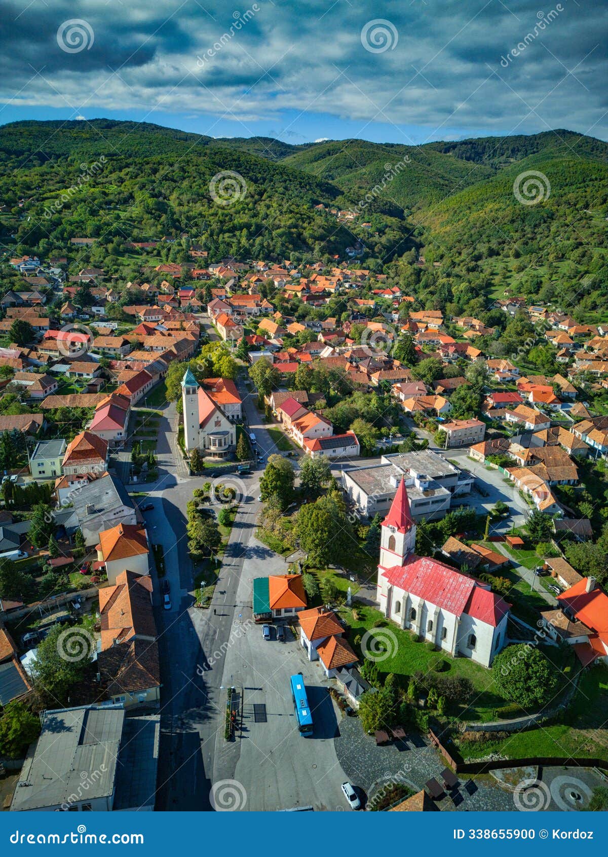 aerial view of namestie mieru square in pukanec village with churches during late summer
