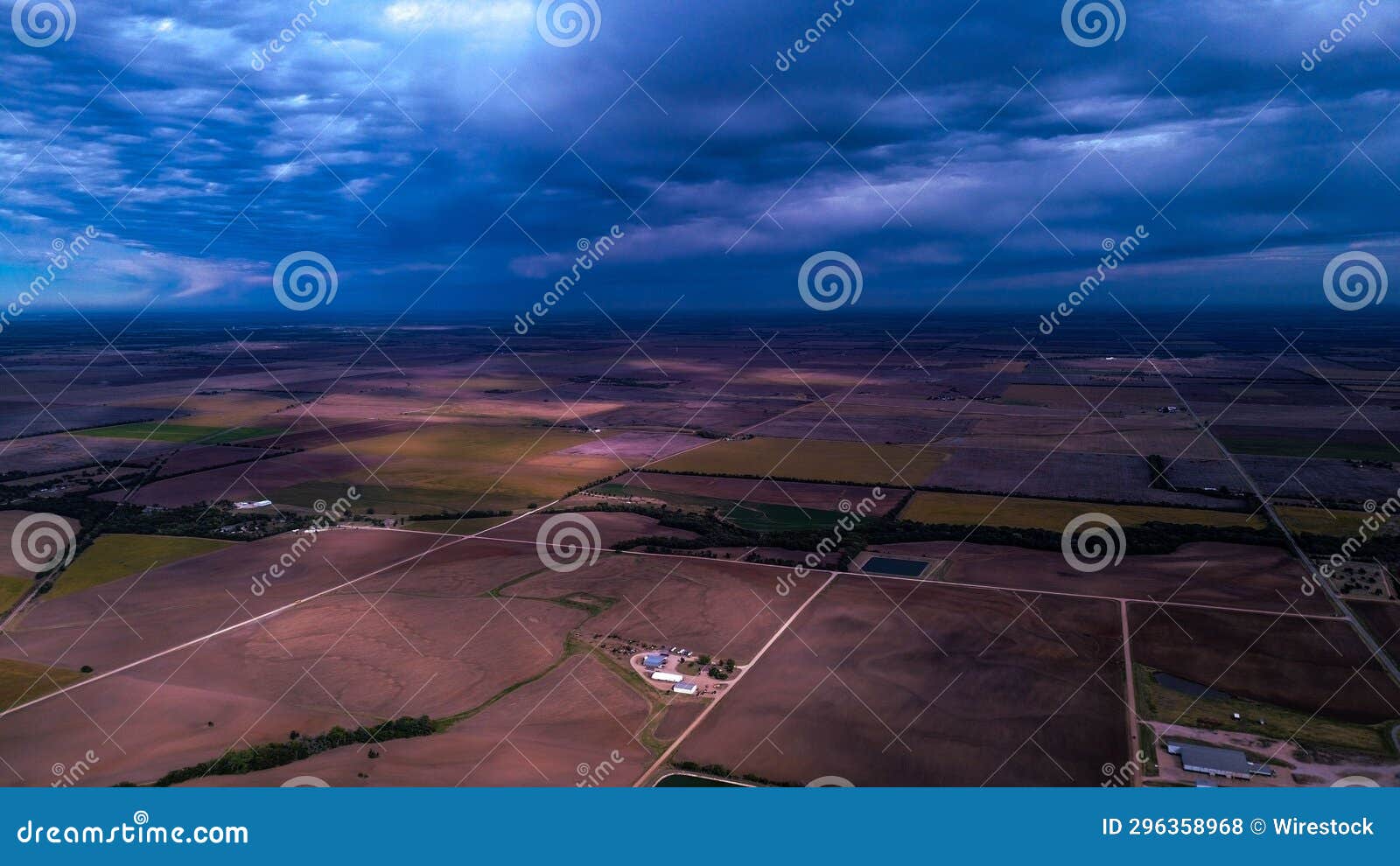 Aerial View Offers an Expansive Landscape with a Field of Crops and 