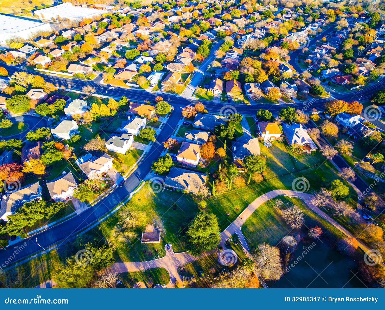 aerial view over modern suburb home community with fall colors