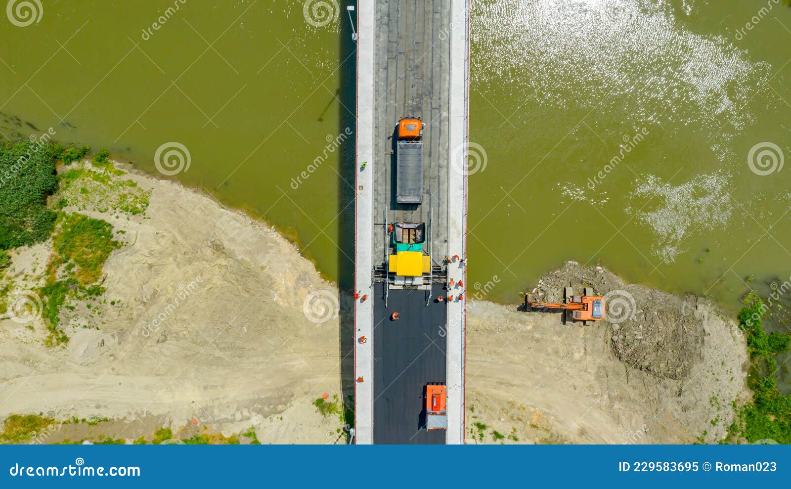 aerial view on people with mechanization laying, spreading asphalt