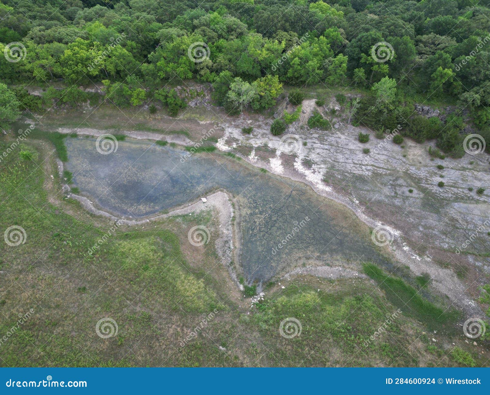Aerial View of a Pond in an Expansive Grassy Field Stock Photo Image