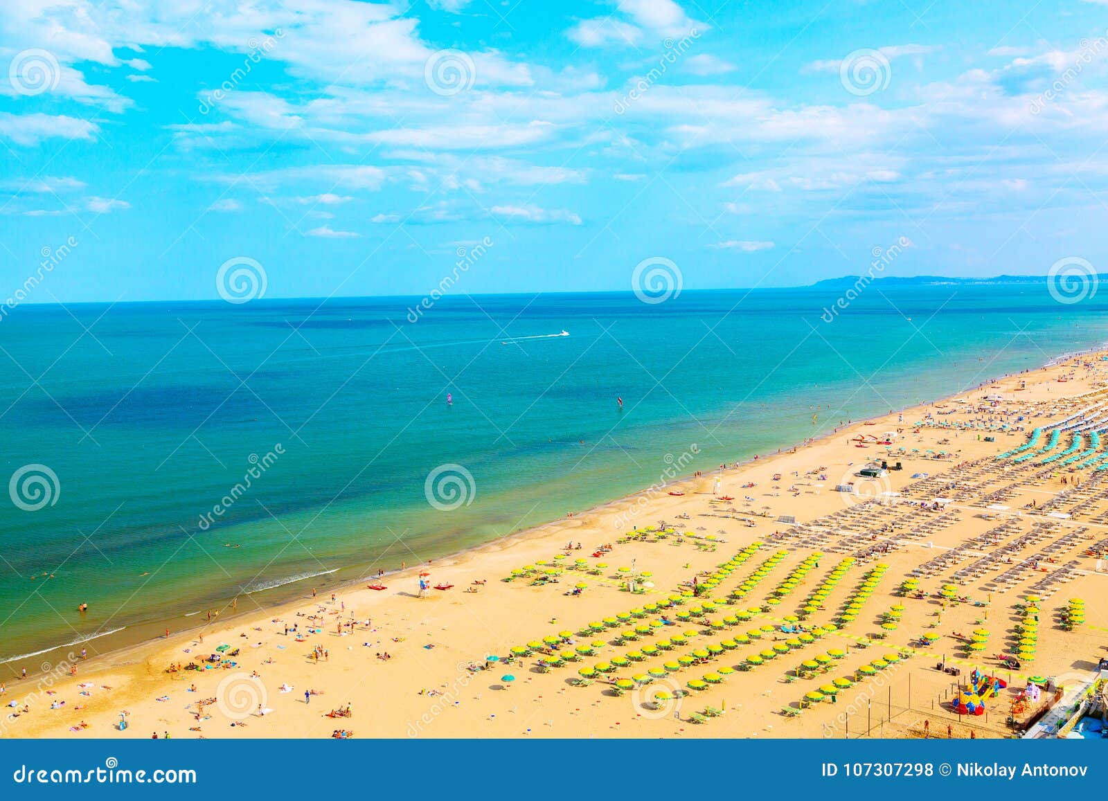 aerial view of rimini beach with people, ships and blue sky. summer vacation concept.