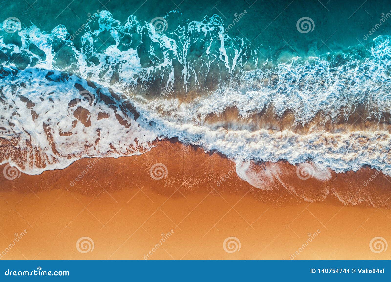 aerial view of sea waves and sandy beach