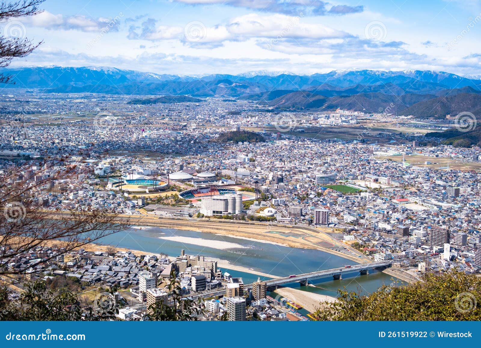 aerial view of the shinano river flowing through gujo cityscape in japan