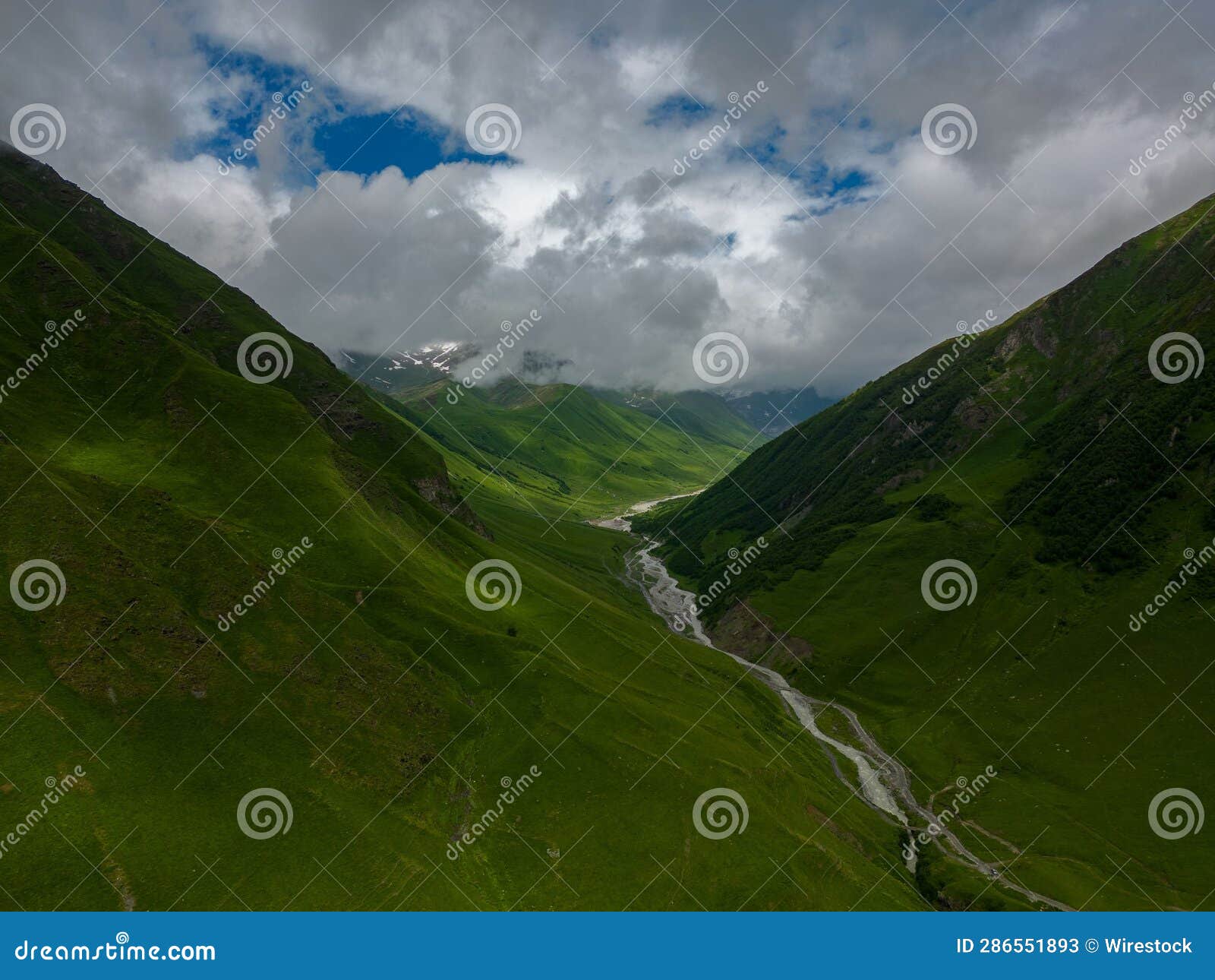 aerial view of st. giorgi in green mountains on a cloudy day in georgia