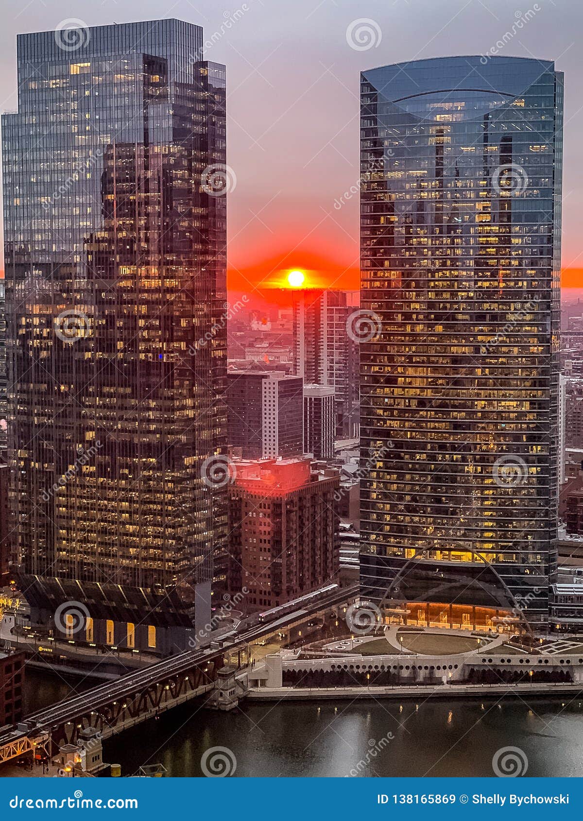 aerial view of stunning ball of sun creating deep orange sunset over chicago loop