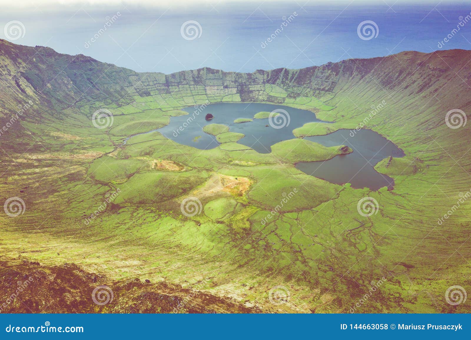 aerial view of volcanic crater caldeirao with a beautiful lake on the top of corvo island. azores islands, portugal