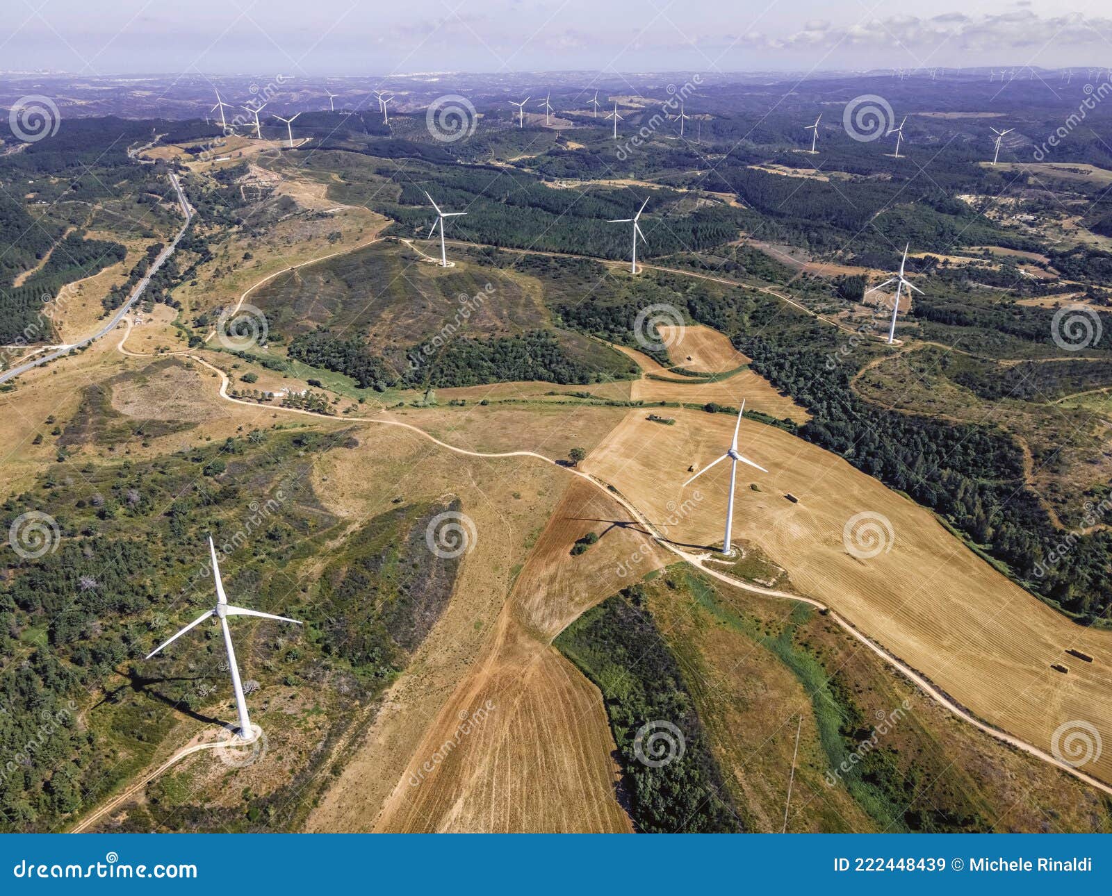 aerial view of a wind turbines in the countryside near monte rubio in faro district, alentejo region, portugal