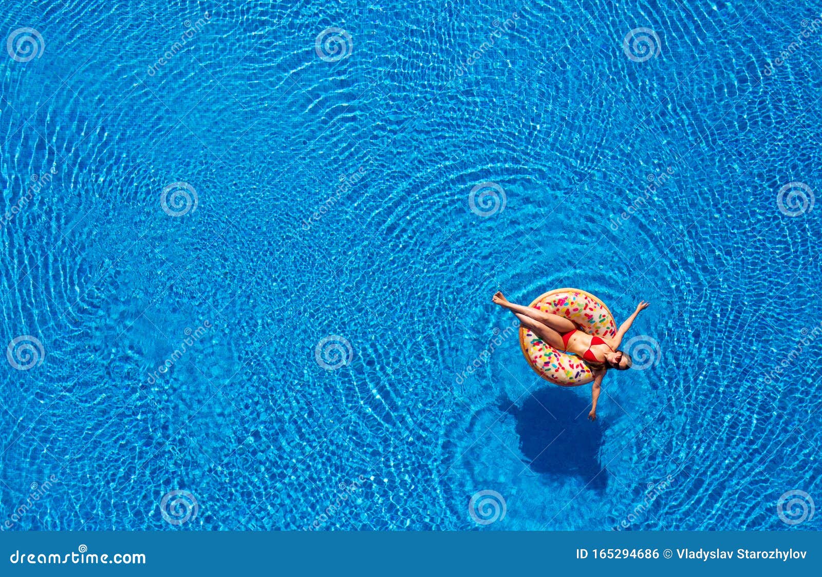 Aerial View of a Woman in Red Bikini Lying on a Donut in the Pool Stock ...