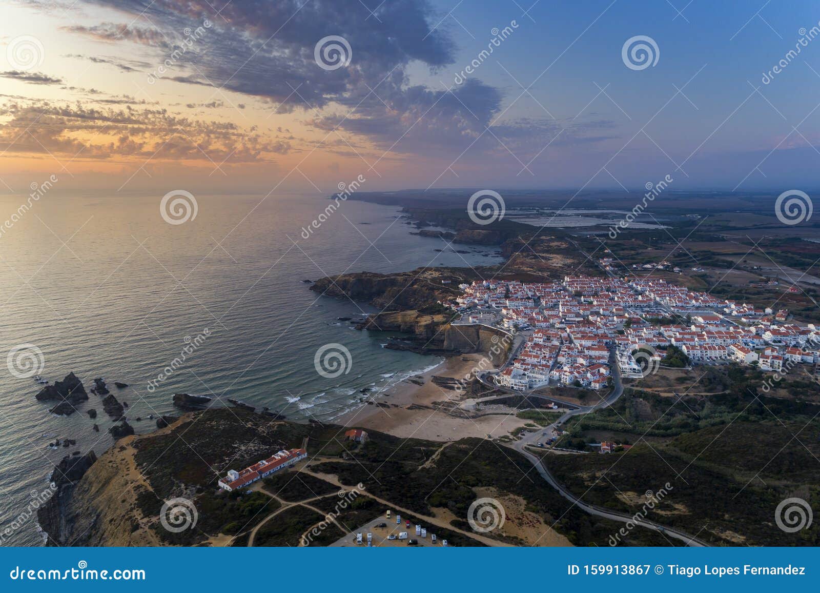 aerial view of the zambujeira do mar village and beach at sunset, in alentejo