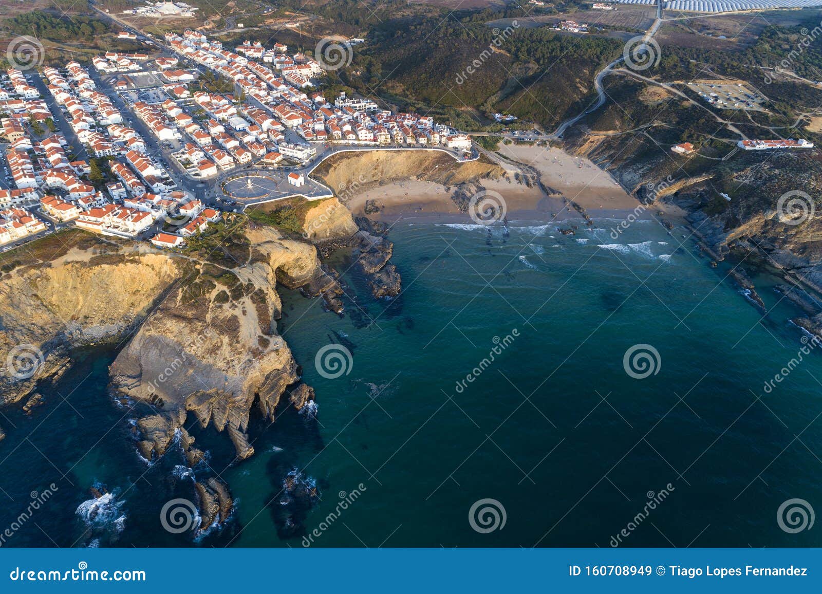 aerial view of the zambujeira do mar village and beach at sunset, in alentejo