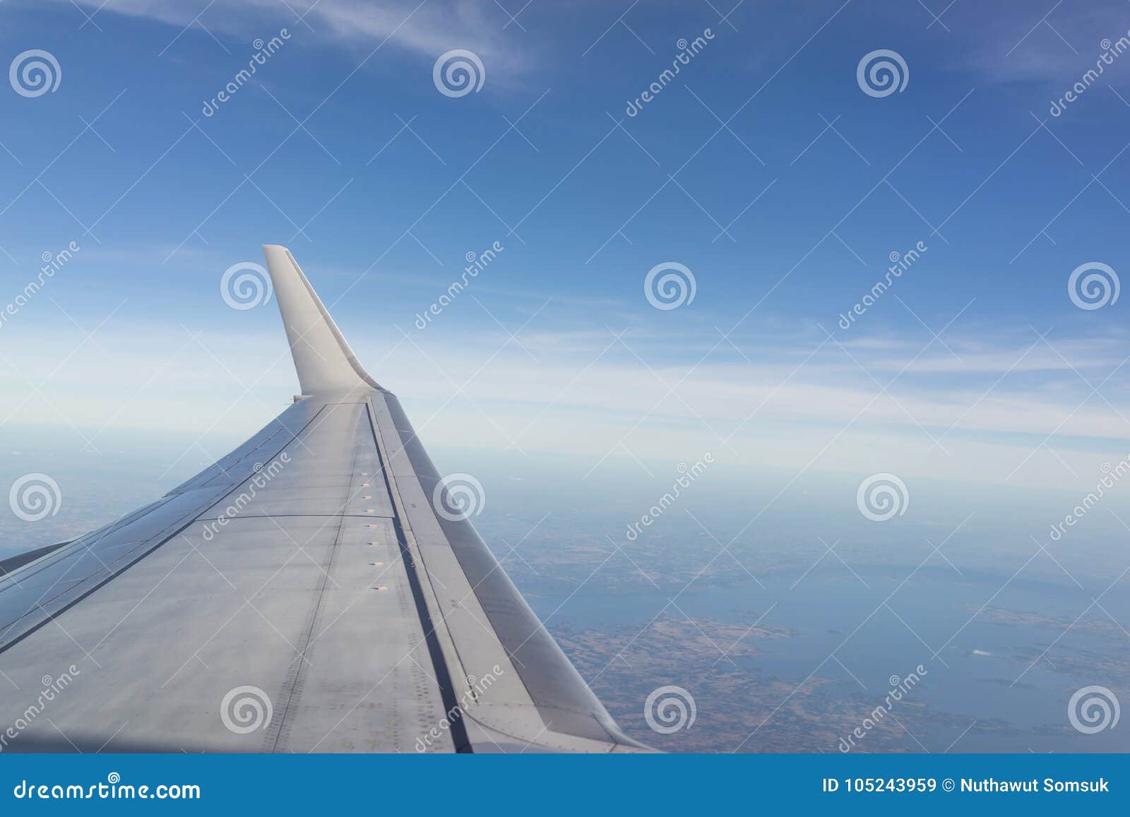 aerial wing of airplane in bright blue sky day light using as va