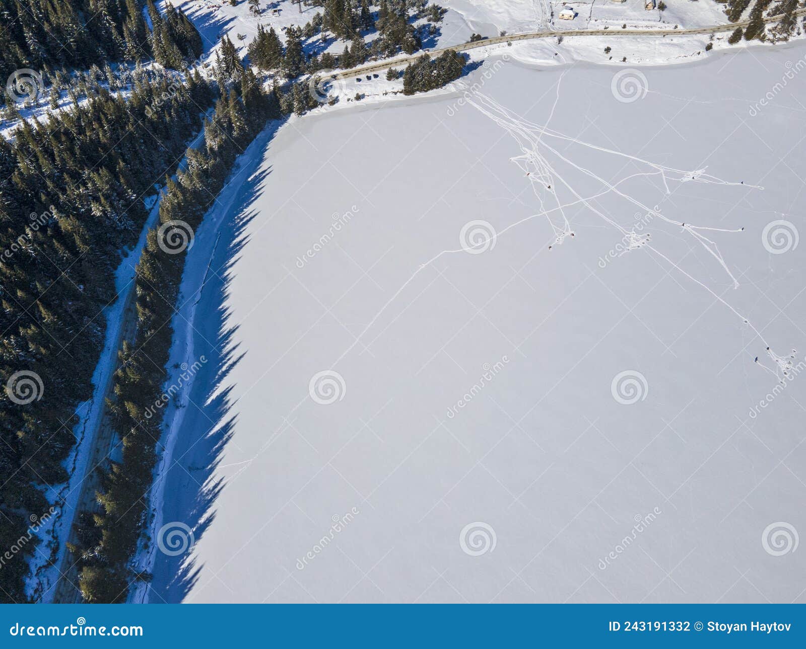 aerial winter view of beglika reservoir covered with ice, bulgaria