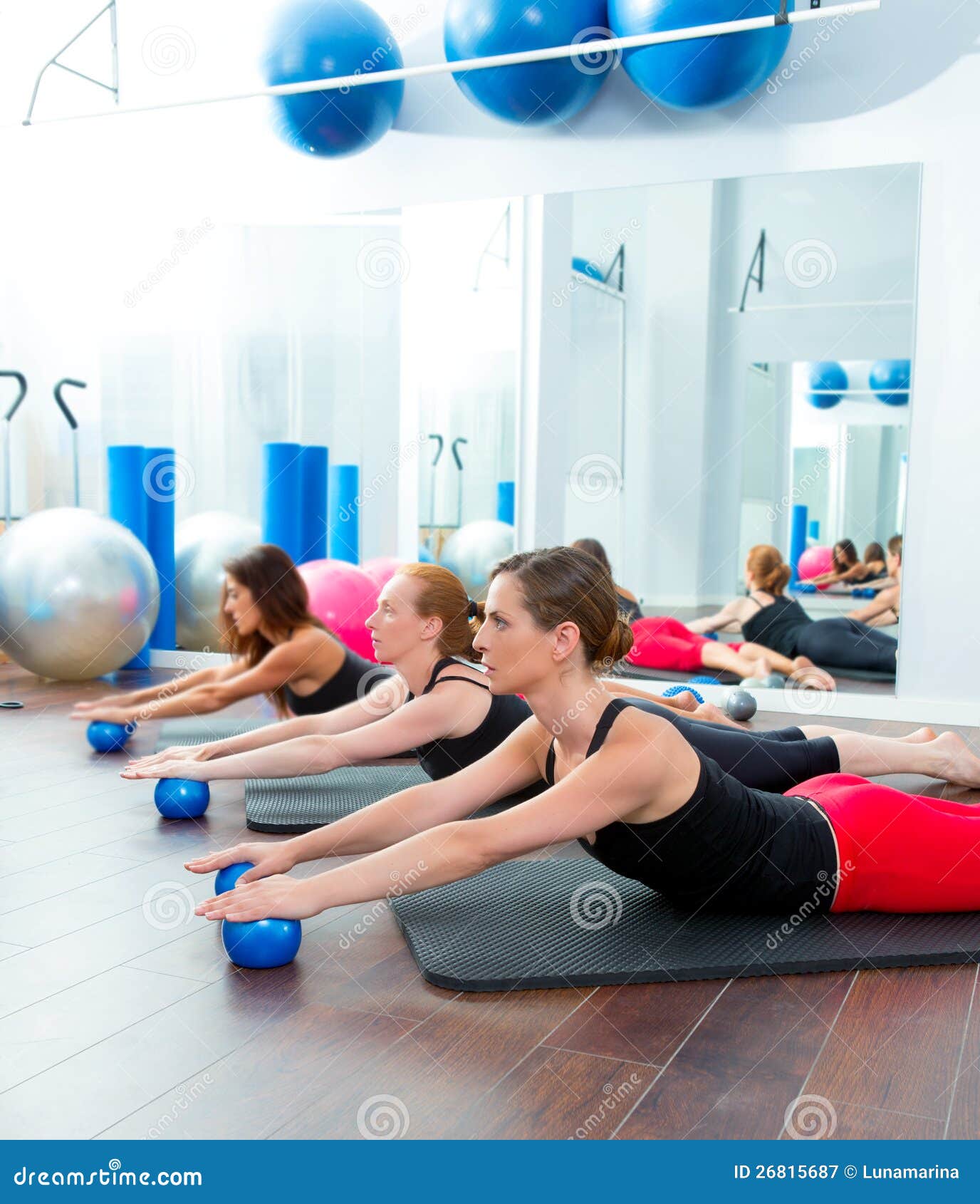 aerobics pilates women with toning balls in a row