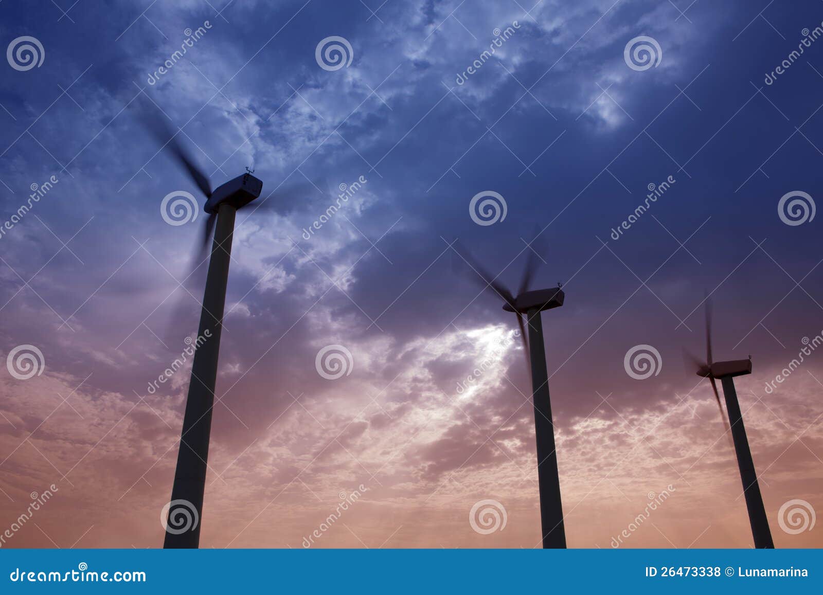 aerogenerator windmills on dramatic sunset sky