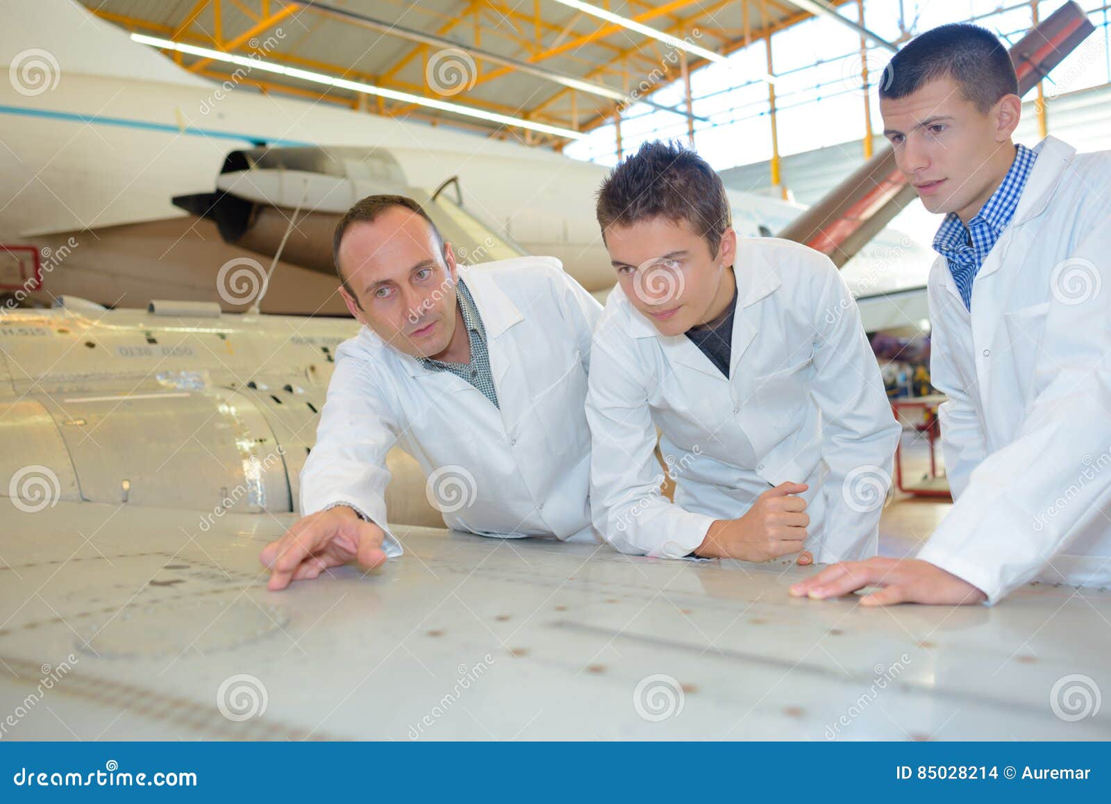 aerospace engineers studying blueprint