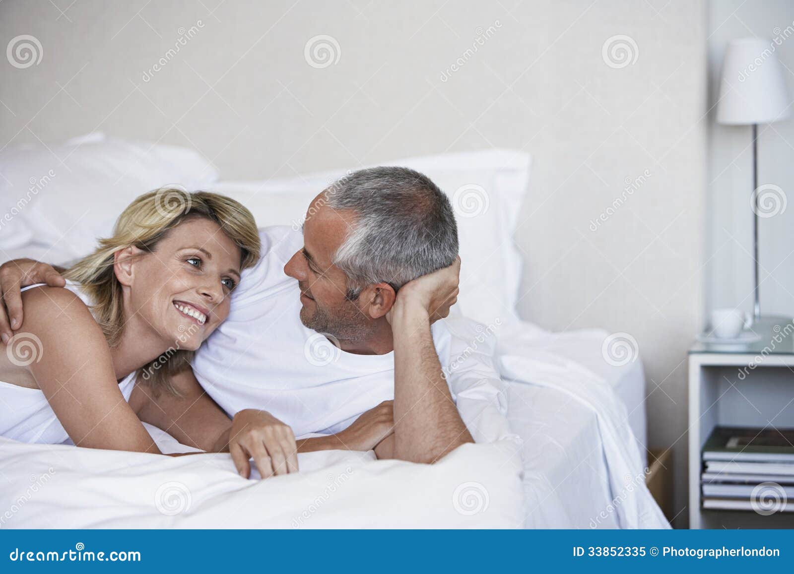 affectionate couple relaxing on bed