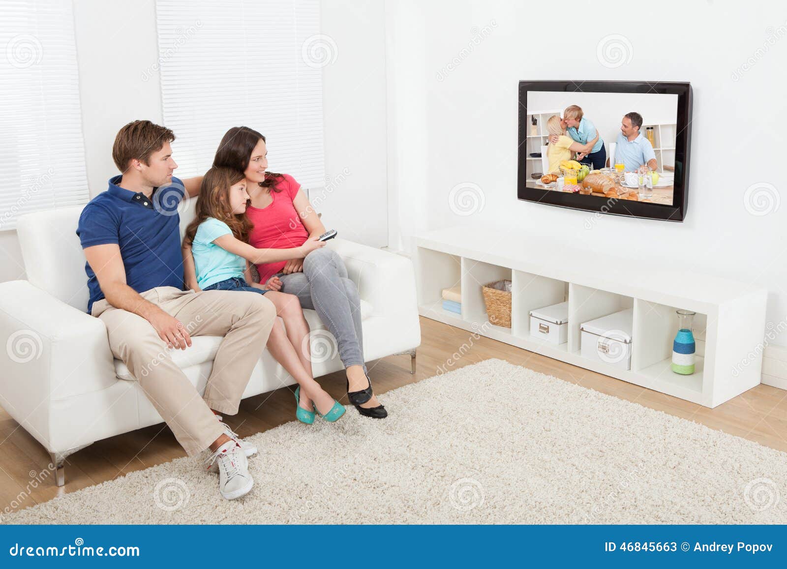 affectionate family watching tv