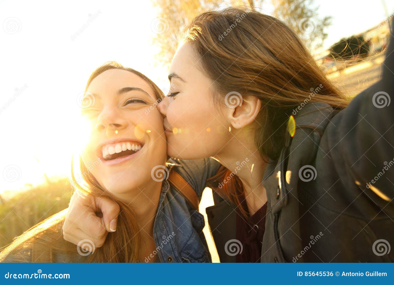Affectionate Friends Kissing and Taking a Selfie Stock Photo ...