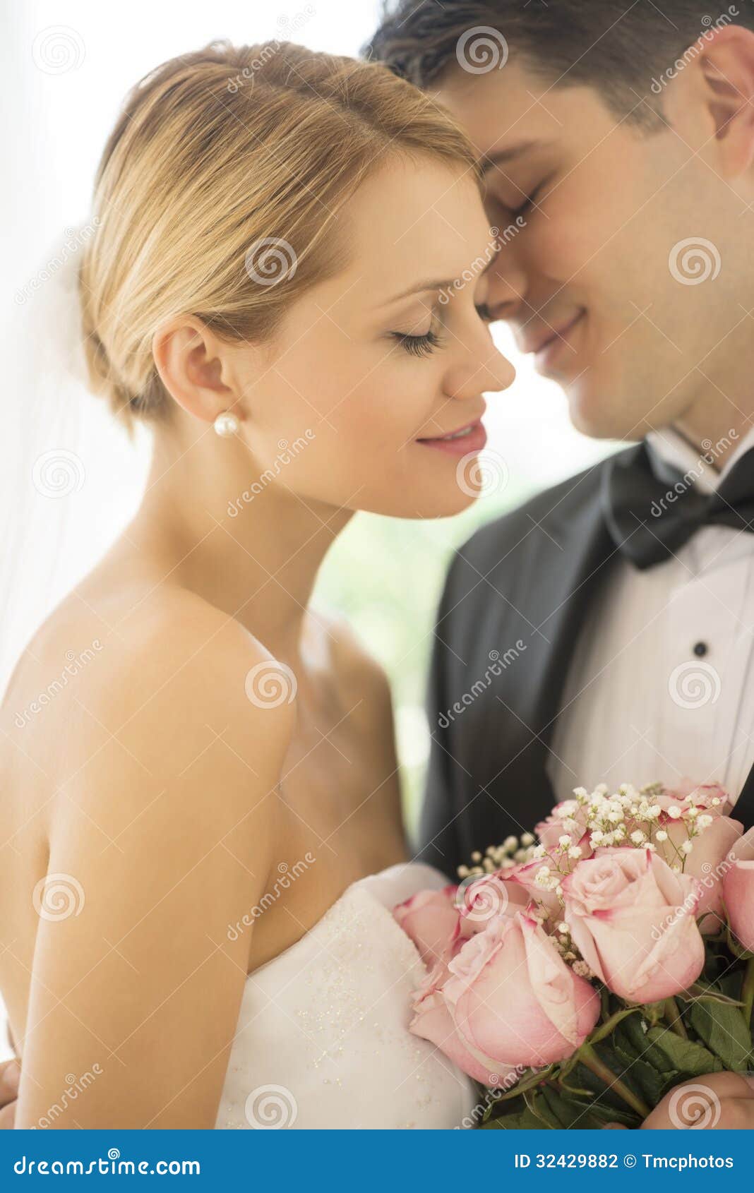 affectionate groom about to kiss bride