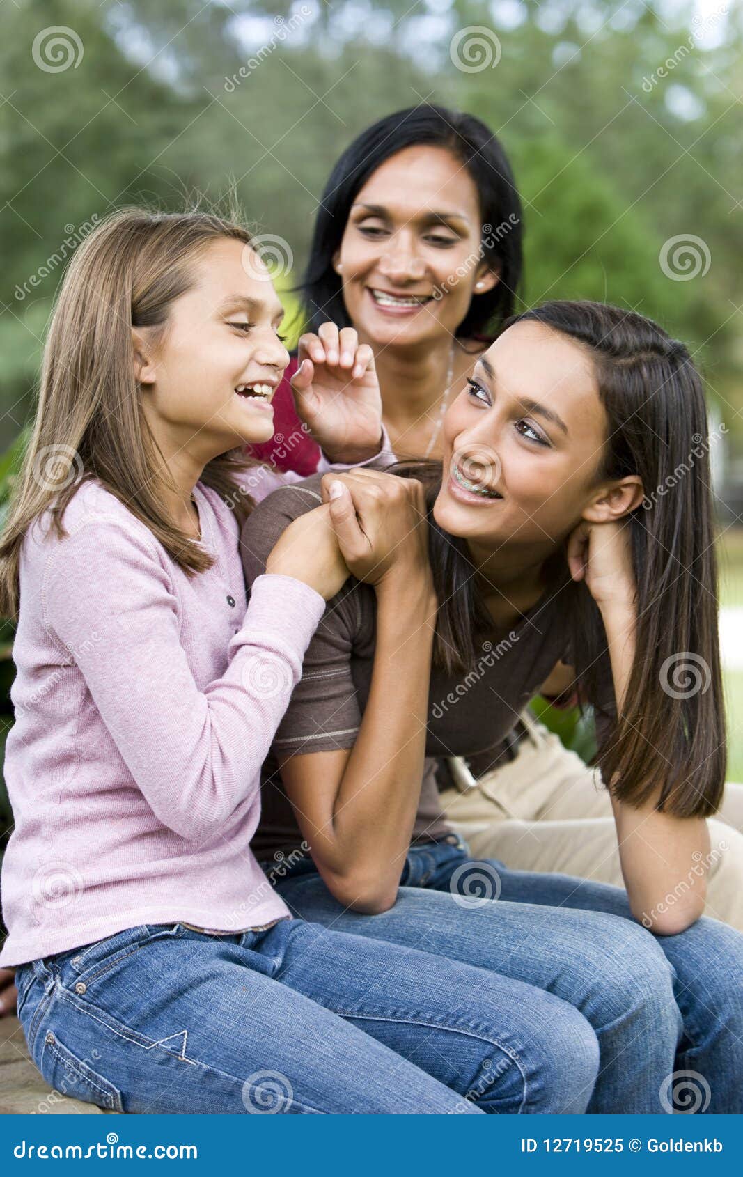 affectionate mother and two daughters laughing