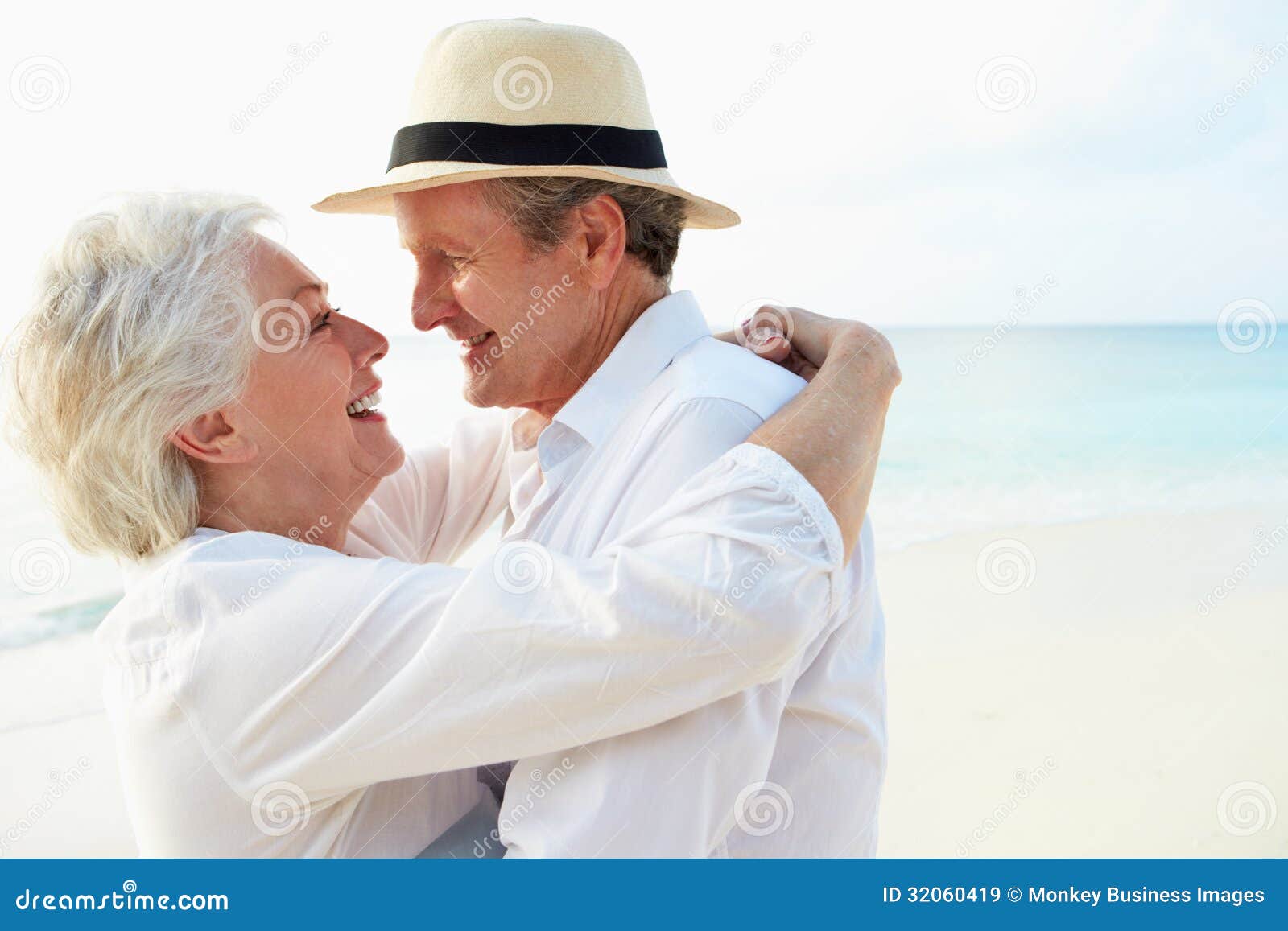 affectionate senior couple on tropical beach holiday