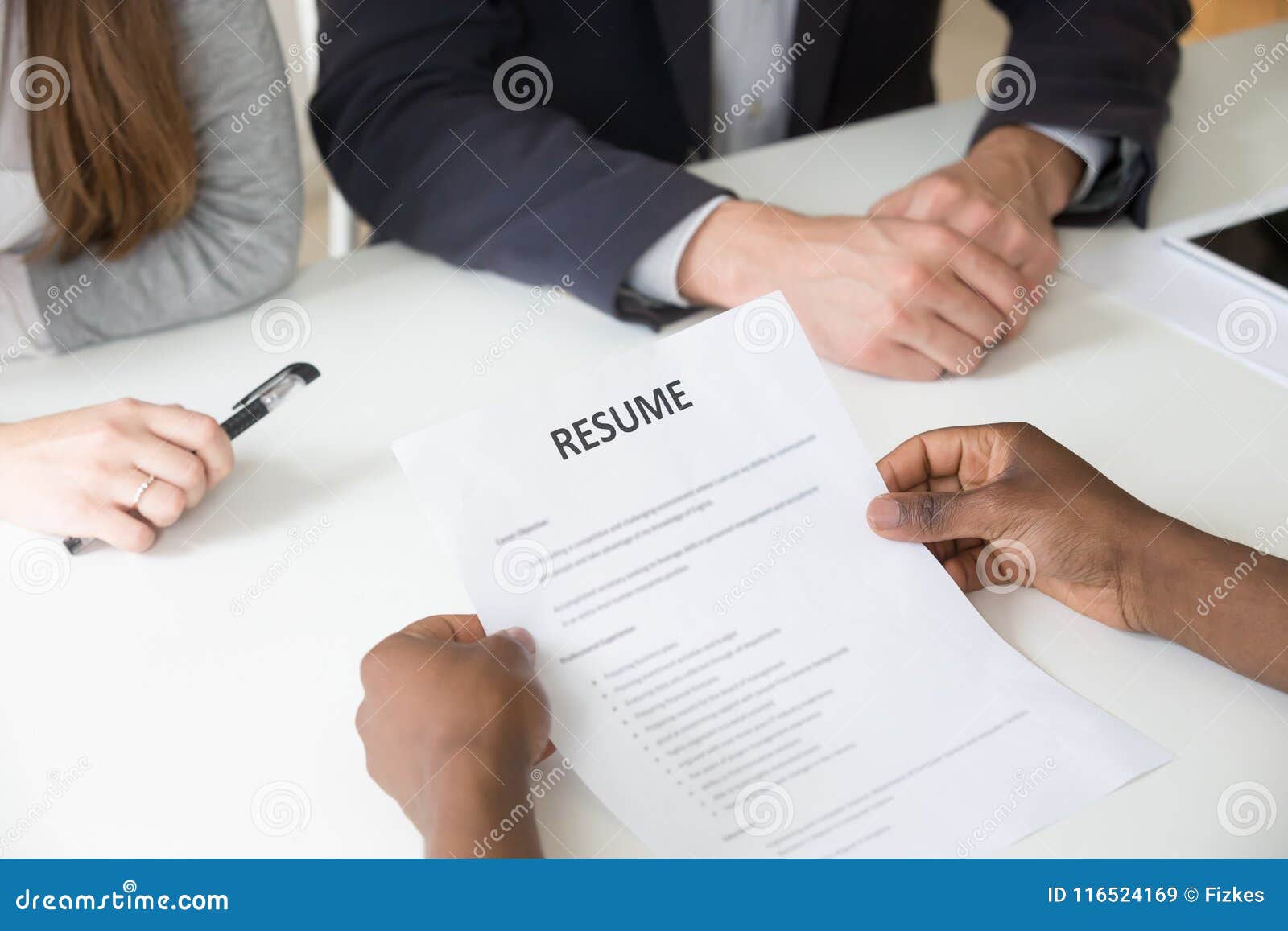african-american applicant holding resume at job interview, clos