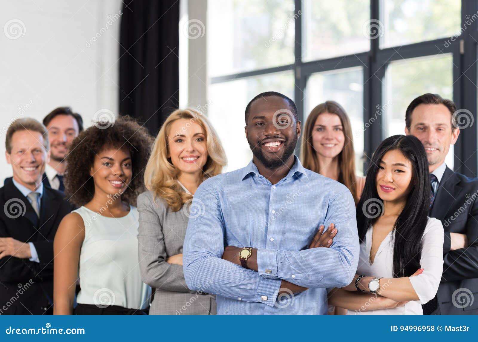 african american businessman boss with group of business people in creative office, successful mix race man leading