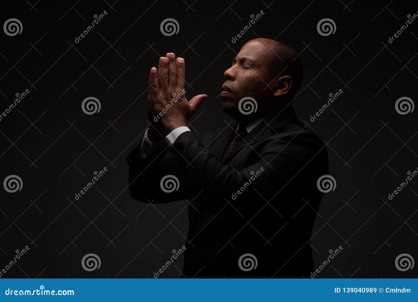 african american christian man praying and seeking guidance from god