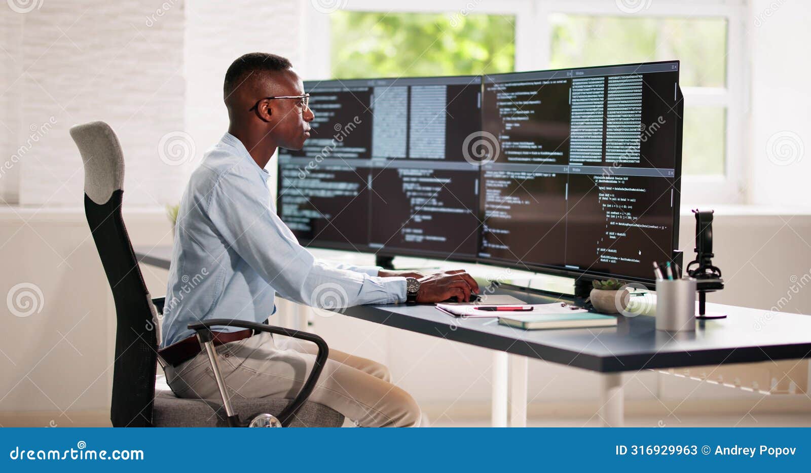 african american coder using computer at desk