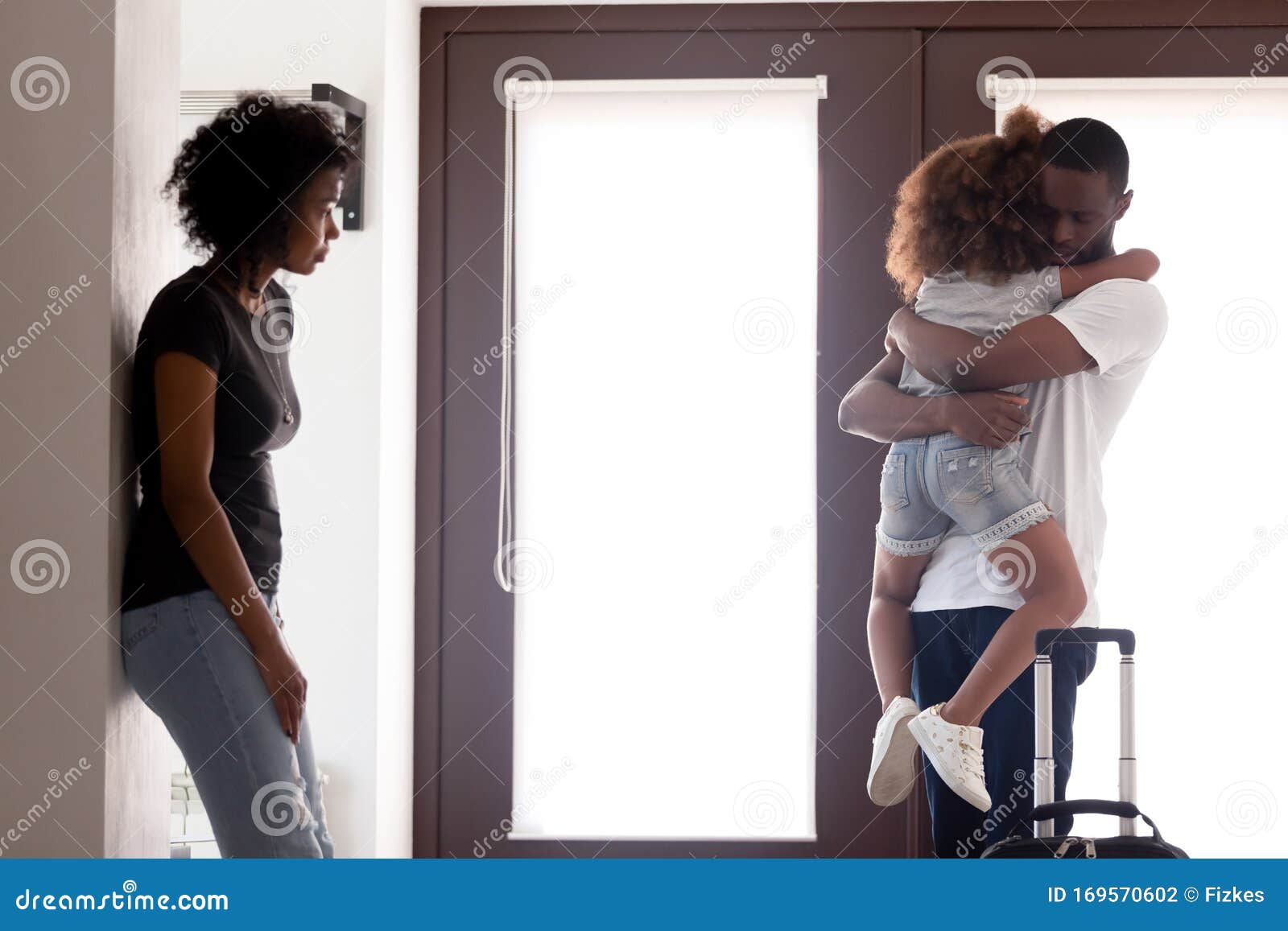 african american dad hug daughter leaving young family