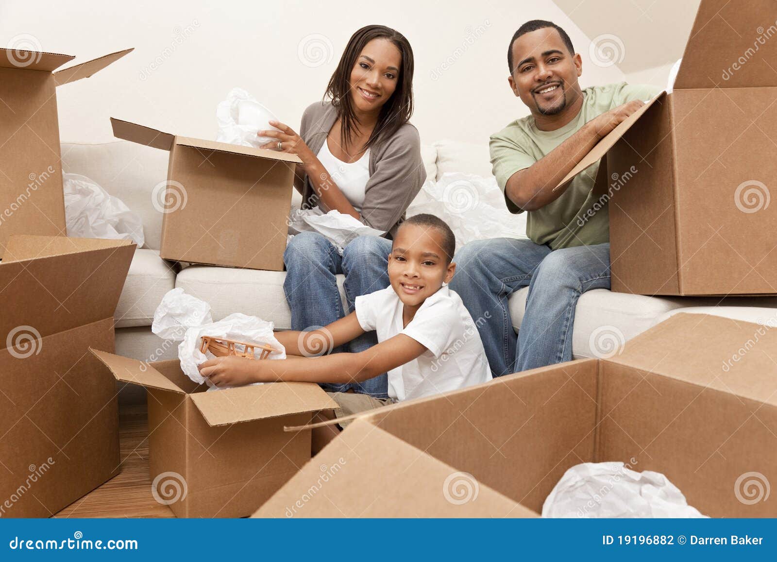 african american family with boxes moving home
