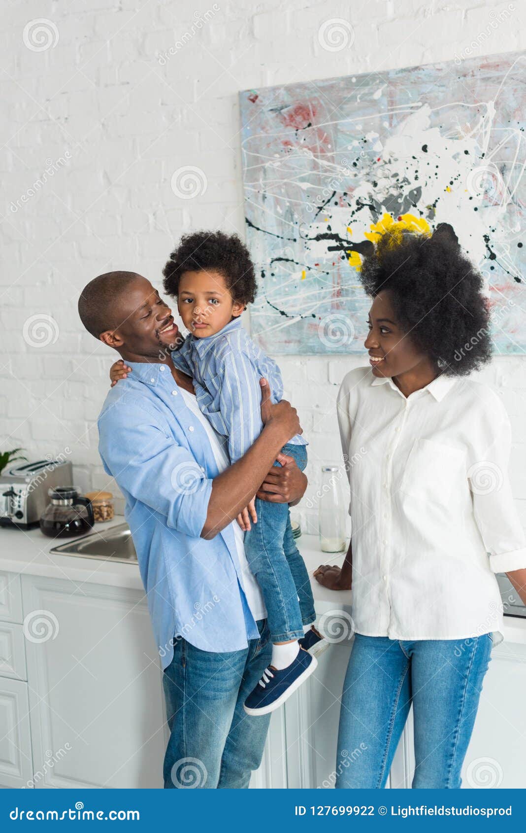  African American Family Standing  In Kitchen In Morning 